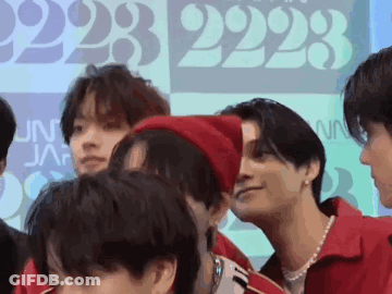 A Group Of Young Men Are Standing Next To Each Other And Talking . GIF