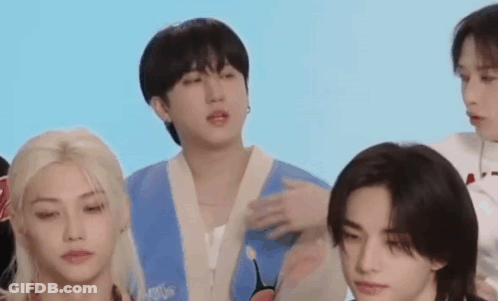 A Group Of Young Men Are Standing Next To Each Other And Talking . GIF