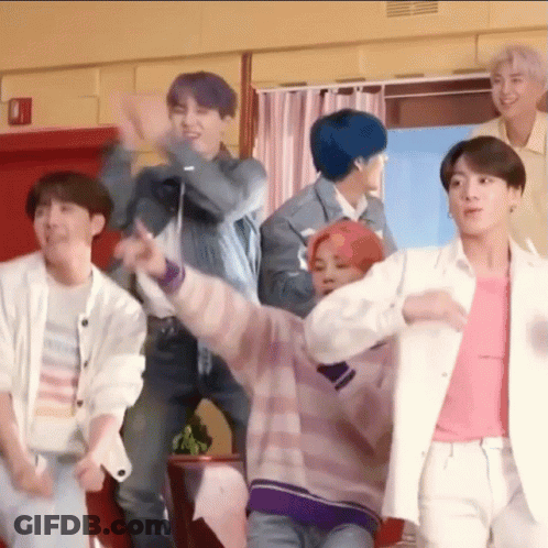 A Group Of Young Men Are Standing Next To Each Other In A Room And Dancing . GIF