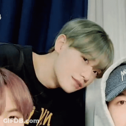 A Group Of Young Men Are Standing Next To Each Other In A Room And Looking At The Camera . GIF