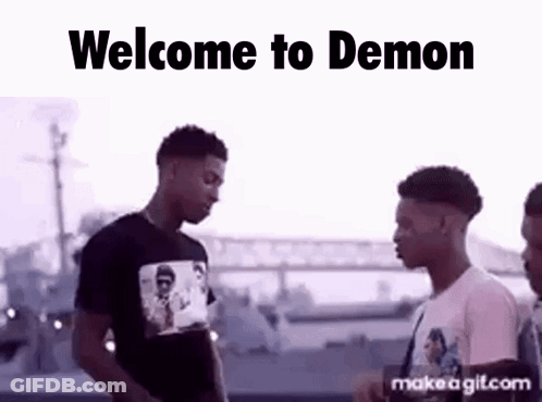 A Group Of Young Men Are Standing Next To Each Other In Front Of A Bridge . GIF