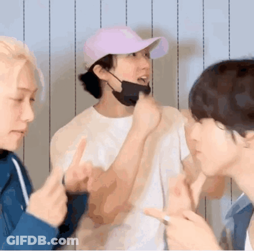 A Group Of Young Men Are Standing Next To Each Other Making Funny Faces . GIF