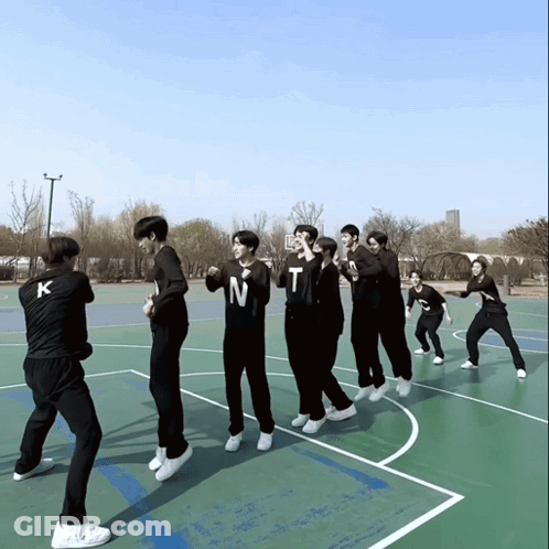A Group Of Young Men Are Standing On A Basketball Court And One Of Them Has The Letter N On His Shirt GIF