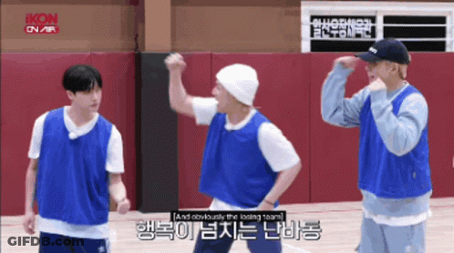 A Group Of Young Men Are Standing On A Basketball Court And One Of Them Is Wearing A Beanie GIF