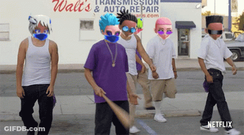 A Group Of Young Men Are Walking Down The Street In Front Of A Walt 'S Transmission And Auto Repair Store GIF