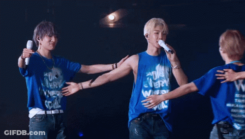 A Group Of Young Men Hugging Each Other Wearing Blue Shirts With The Letter W On Them GIF