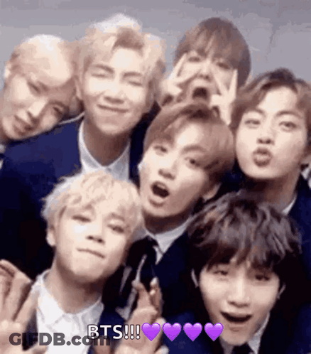A Group Of Young Men In Suits And Ties Are Posing For A Picture Together . GIF