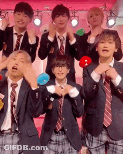 A Group Of Young Men In Suits And Ties Are Posing For A Picture . GIF