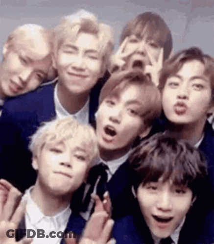 A Group Of Young Men In Suits And Ties Posing For A Picture . GIF
