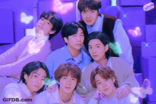 A Group Of Young Men Posing For A Picture With A Purple Background GIF