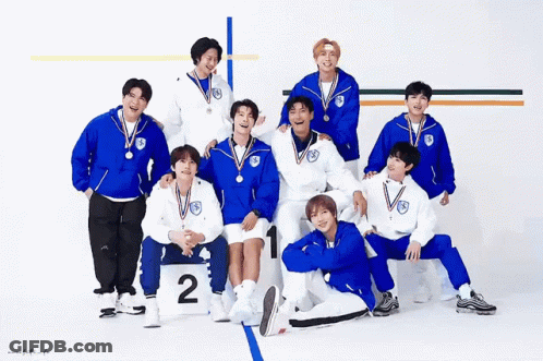 A Group Of Young Men Posing For A Picture With Medals Around Their Necks GIF
