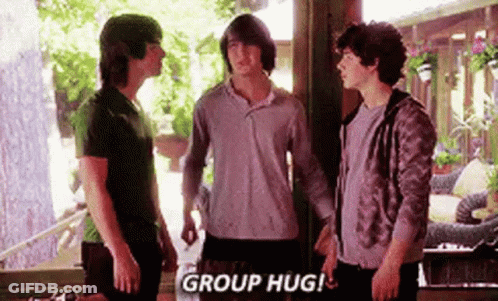 A Group Of Young Men Standing Next To Each Other In A Room . GIF