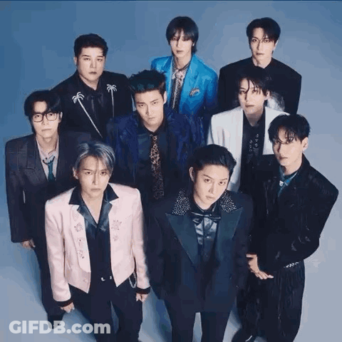 A Group Of Young Men Standing Next To Each Other In Suits And Ties . GIF