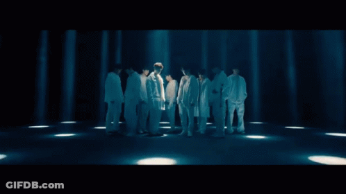 A Group Of Young Men Standing Next To Each Other Wearing White GIF