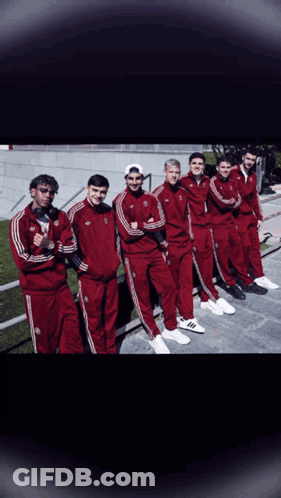 A Group Of Young Men Wearing Red Adidas Tracksuits Pose For A Picture GIF