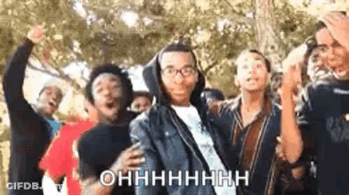 A Group Of Young People Are Dancing Together And One Of Them Is Wearing Glasses And A Hoodie . GIF