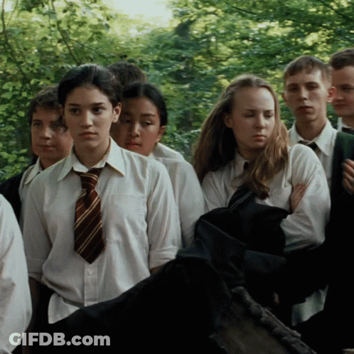 A Group Of Young People Are Standing In A Line GIF