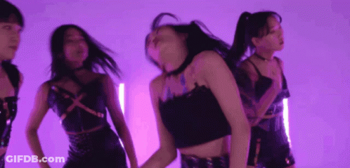 A Group Of Young Women Are Dancing In A Purple Room GIF