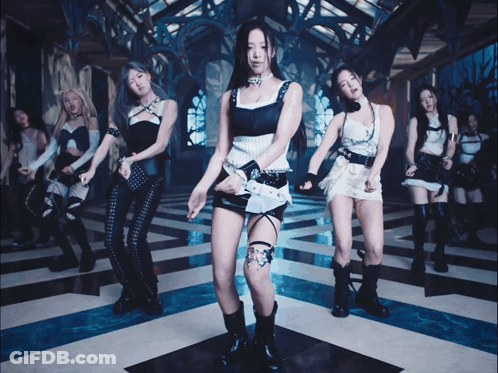 A Group Of Young Women Are Dancing In A Room With A Blue And White Checkered Floor GIF