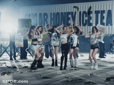 A Group Of Young Women Are Dancing In Front Of A Sign That Says Sugar Honey Ice Tea GIF