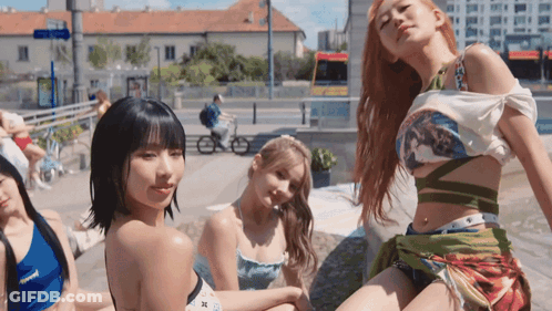 A Group Of Young Women Are Posing For A Picture In Front Of A City Street GIF