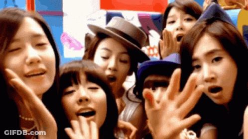 A Group Of Young Women Are Posing For A Picture Together GIF