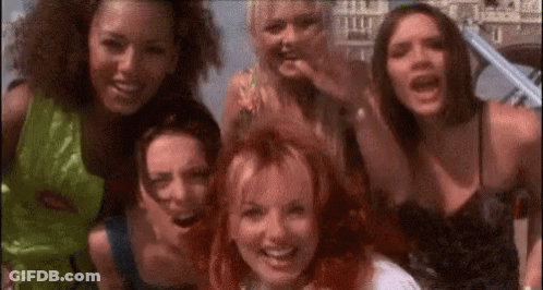 A Group Of Young Women Are Posing For A Picture Together . GIF