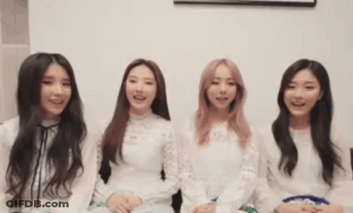 A Group Of Young Women Are Sitting Next To Each Other And Smiling GIF