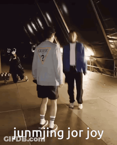 A Guess Shirt Is Being Worn By A Man GIF