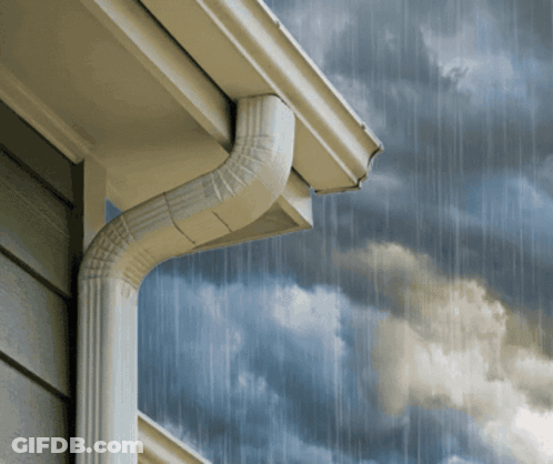 A Gutter On The Side Of A House With A Cloudy Sky Behind It GIF