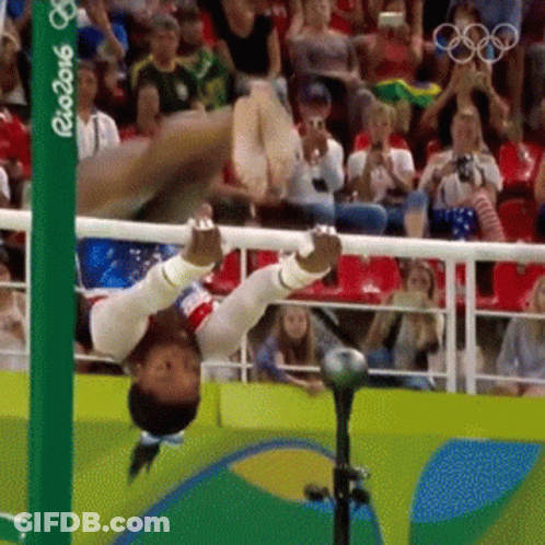 A Gymnast Is Doing A Handstand In Front Of A Crowd At The Rio 2016 Games GIF