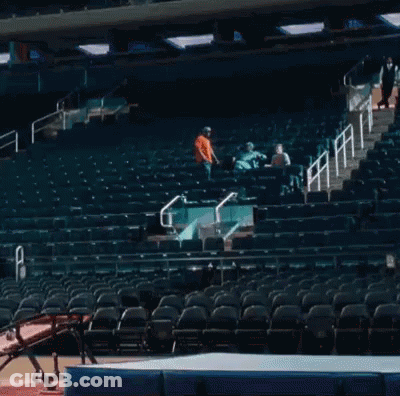 A Gymnast Is Jumping Over A Mat In A Stadium GIF