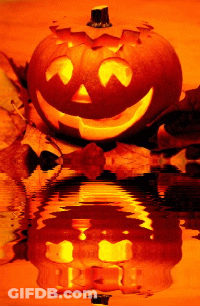 A Halloween Pumpkin With A Face Carved Into It Is Reflected In A Body Of Water GIF