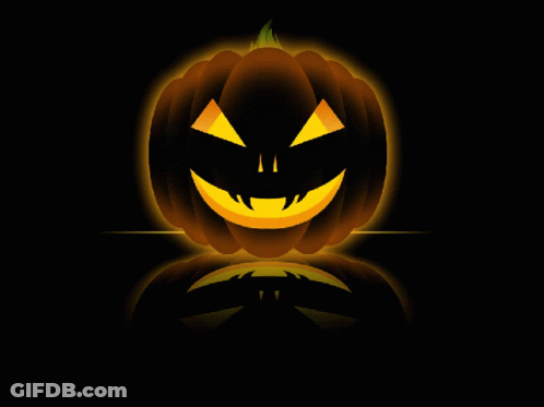 A Halloween Pumpkin With A Glowing Face On A Dark Background GIF