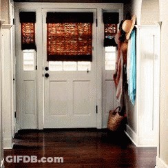 A Hallway With A White Door And A Wicker Basket On The Floor GIF