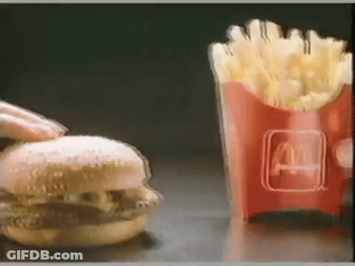 A Hamburger Is Being Eaten Next To A Mcdonald 'S French Fries GIF