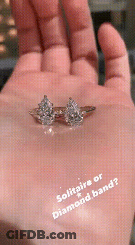 A Hand Holding A Diamond Ring With The Words Solitaire Or Diamond Band GIF
