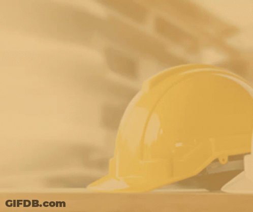 A Hand Holding A Hard Hat With A Hammer And A City In The Background GIF