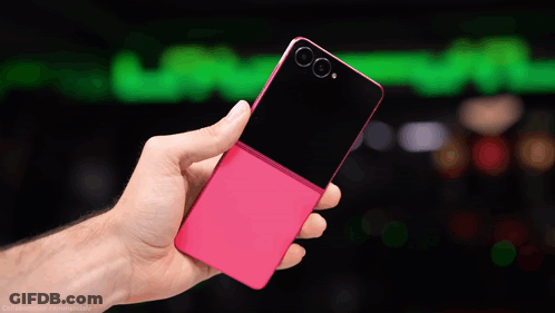 A Hand Holding A Pink And Black Cell Phone GIF
