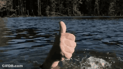 A Hand Is Giving A Thumbs Up In The Water GIF