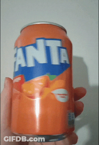 A Hand Is Holding A Can Of Orange Fanta GIF