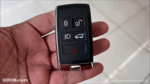 A Hand Is Holding A Car Key That Has The Letters E And D On The Buttons GIF