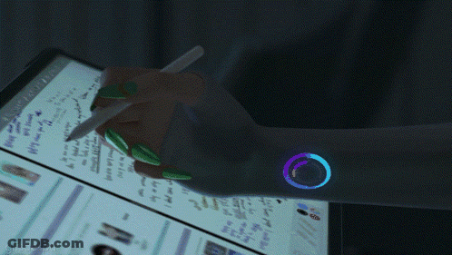 A Hand Is Holding A Pen In Front Of A Computer Screen That Says " Search " GIF
