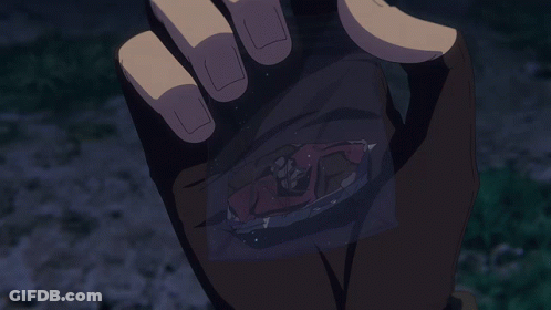 A Hand Is Holding A Piece Of Paper With A Picture Of A Person On It GIF