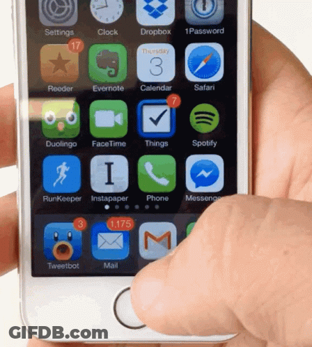 A Hand Is Holding A Smart Phone With The Home Screen Showing Apps Such As Dropbox And Safari GIF