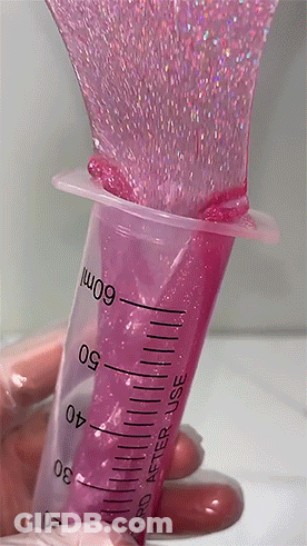 A Hand Is Holding A Syringe That Says 60Ml GIF