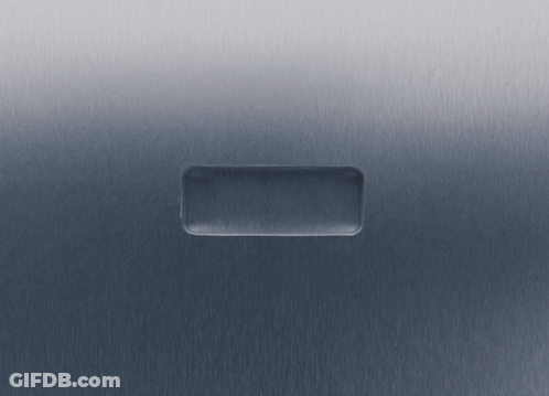 A Hand Is Pressing A Button On A Gray Surface GIF