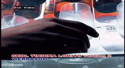 A Hand Is Reaching For A Glass In A Video Titled Skol Tindaka Lokito Version 2 GIF