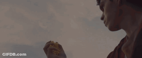 A Hand Is Reaching Out Towards A Flock Of Birds In The Sky GIF