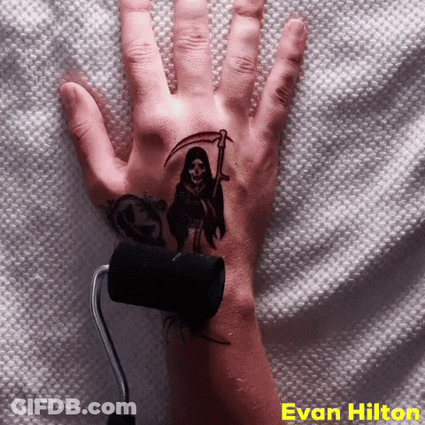 A Hand With A Grim Reaper Tattoo On It GIF